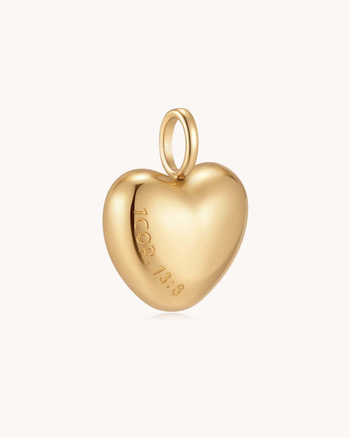 Angled view of Love Never Fails 1 Corinthians 13:8 Gold Heart Pendant