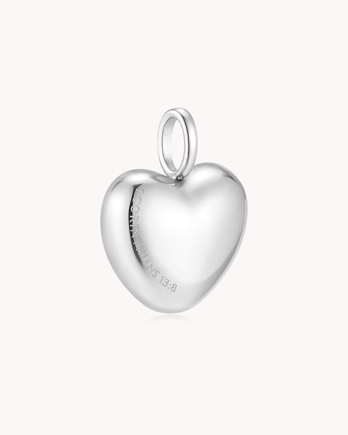 Angled view of Love Never Fails 1 Corinthians 13:8 White Gold Heart Pendant