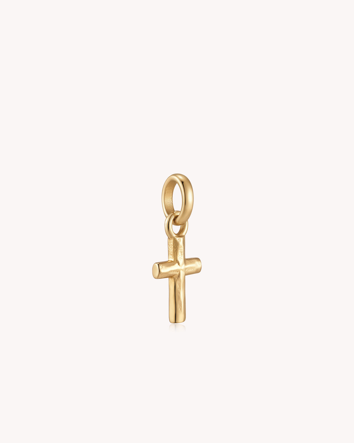Angled view of Gold Petite Textured Cross Pendant