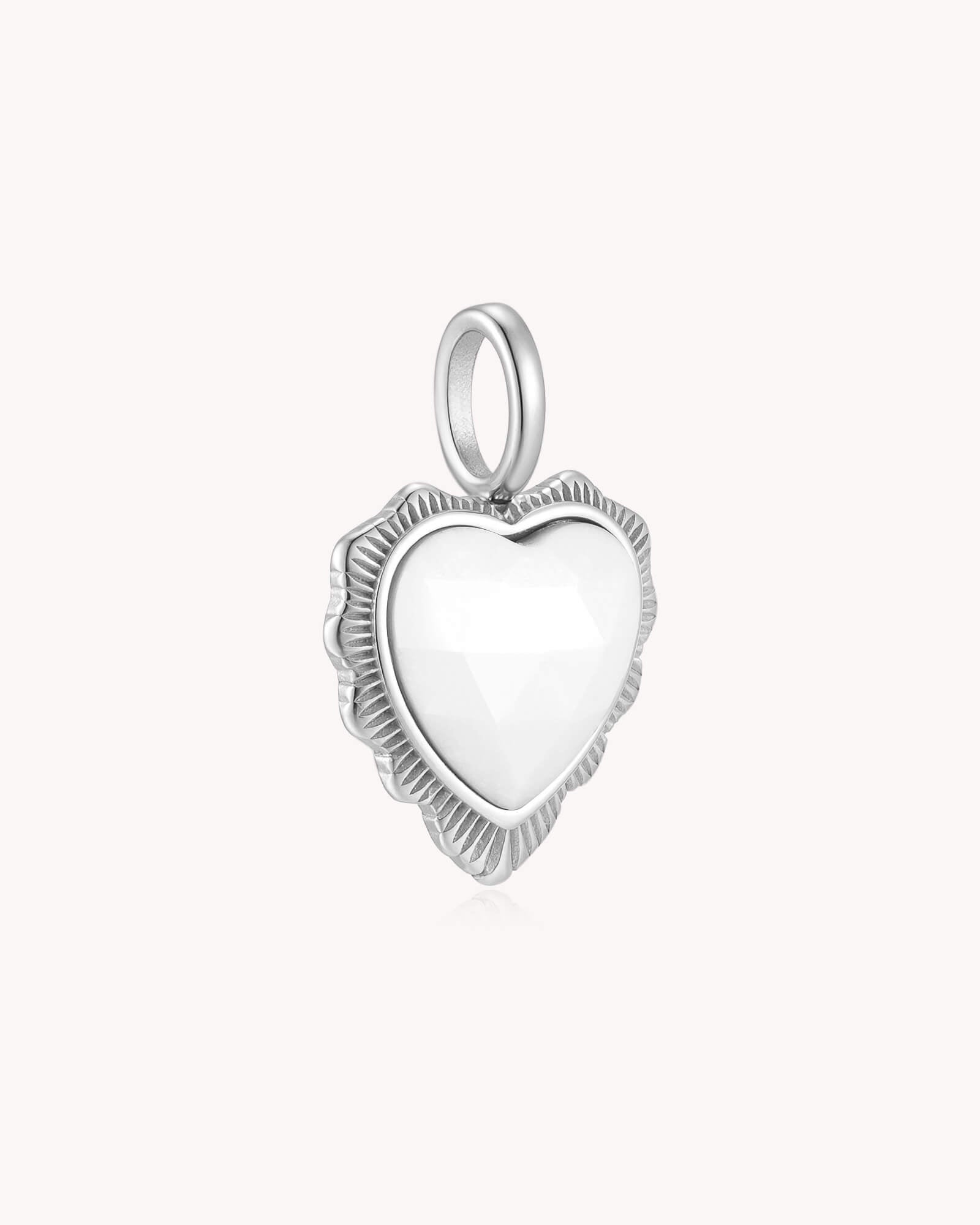 Angled view of Take Heart John 16:33 White Gold White Onyx Heart Pendant