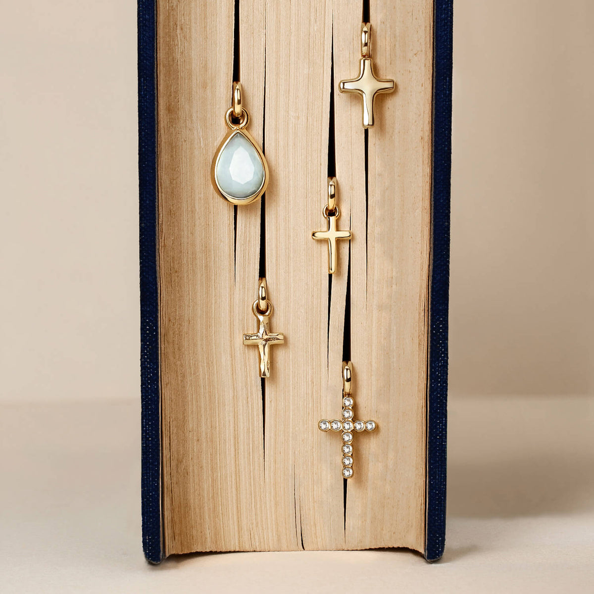 Gold pendants displayed in between the pages of a bible.