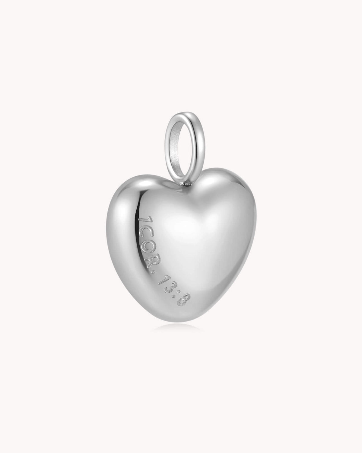 Angled view of Love Never Fails 1 Corinthians 13:8 White Gold Heart Pendant