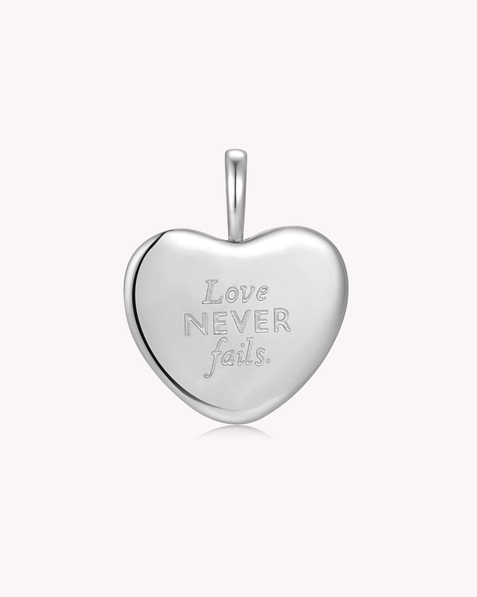 Back of Love Never Fails 1 Corinthians 13:8 White Gold Heart Pendant