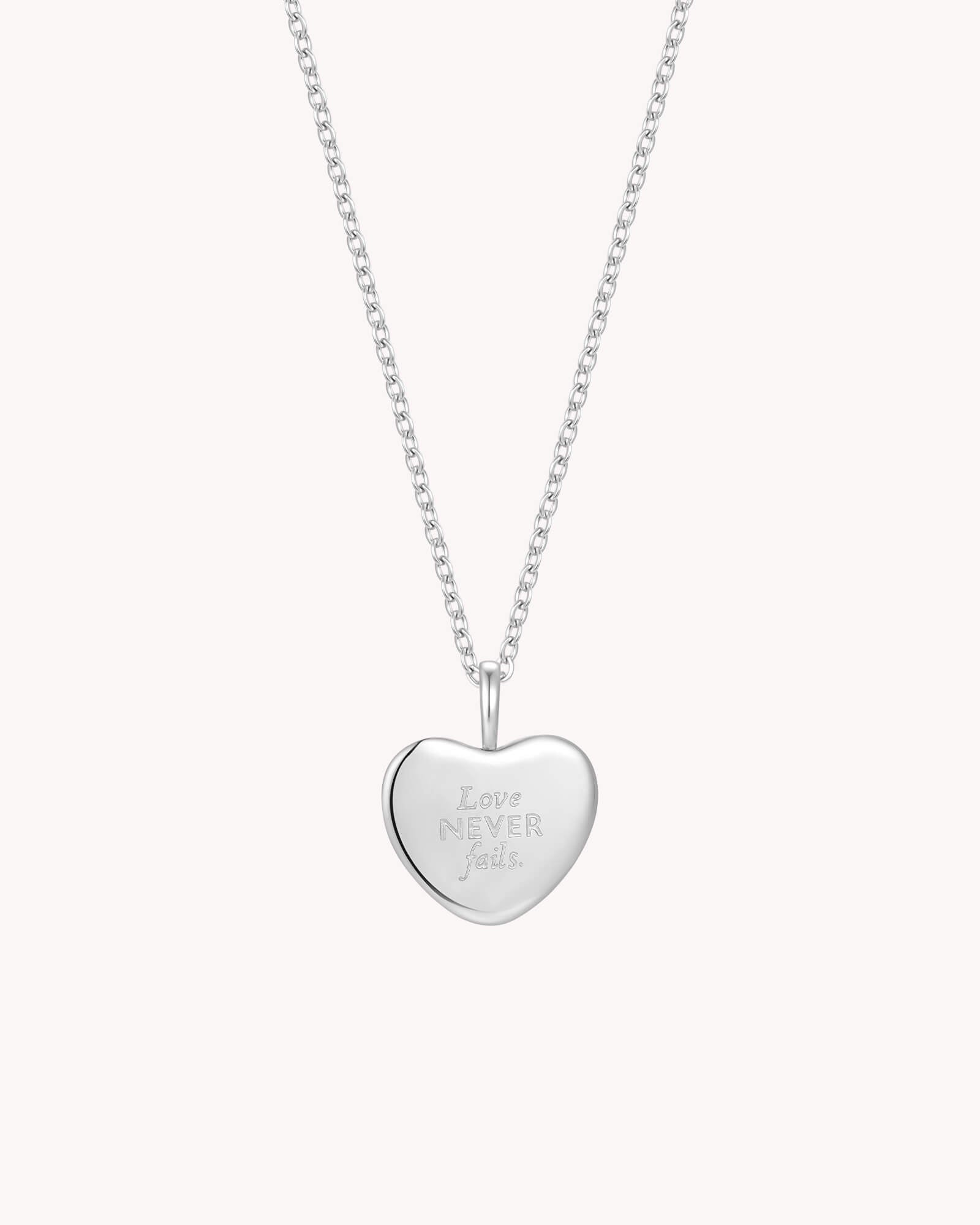 Back of 1 Corinthians 13:8 Love Never Fails White Gold Heart Necklace