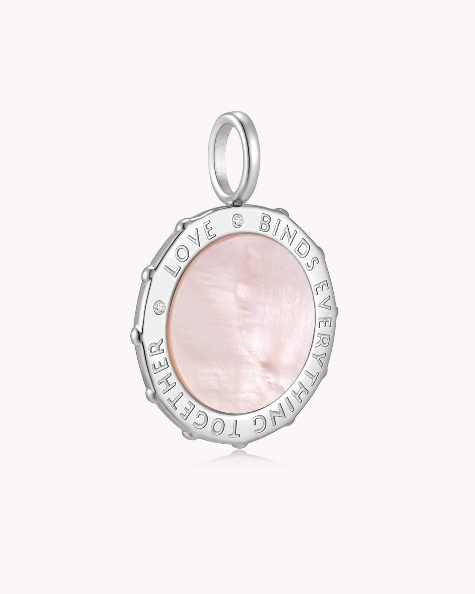 Angled view of Love Binds Everything Together Colossians 3:14 White Gold Medallion