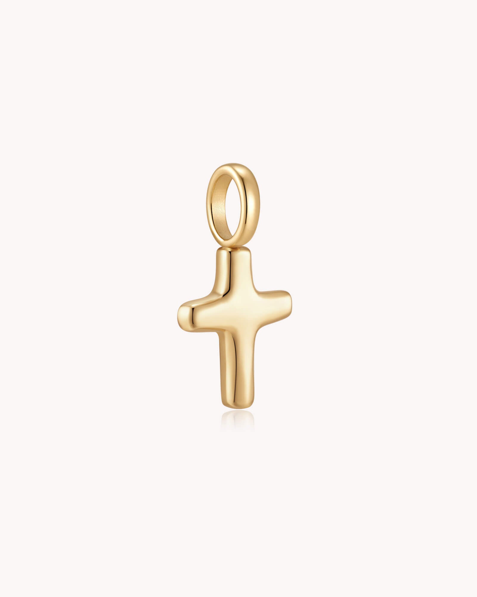 Angled view of Gold Petite Puff Cross Pendant