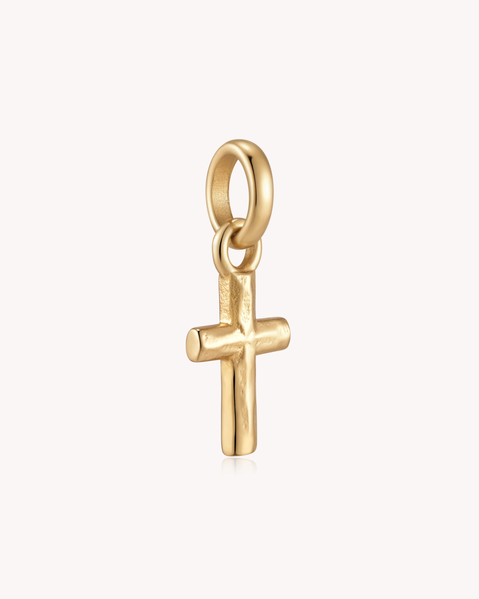 Angled view of Gold Petite Textured Cross Pendant