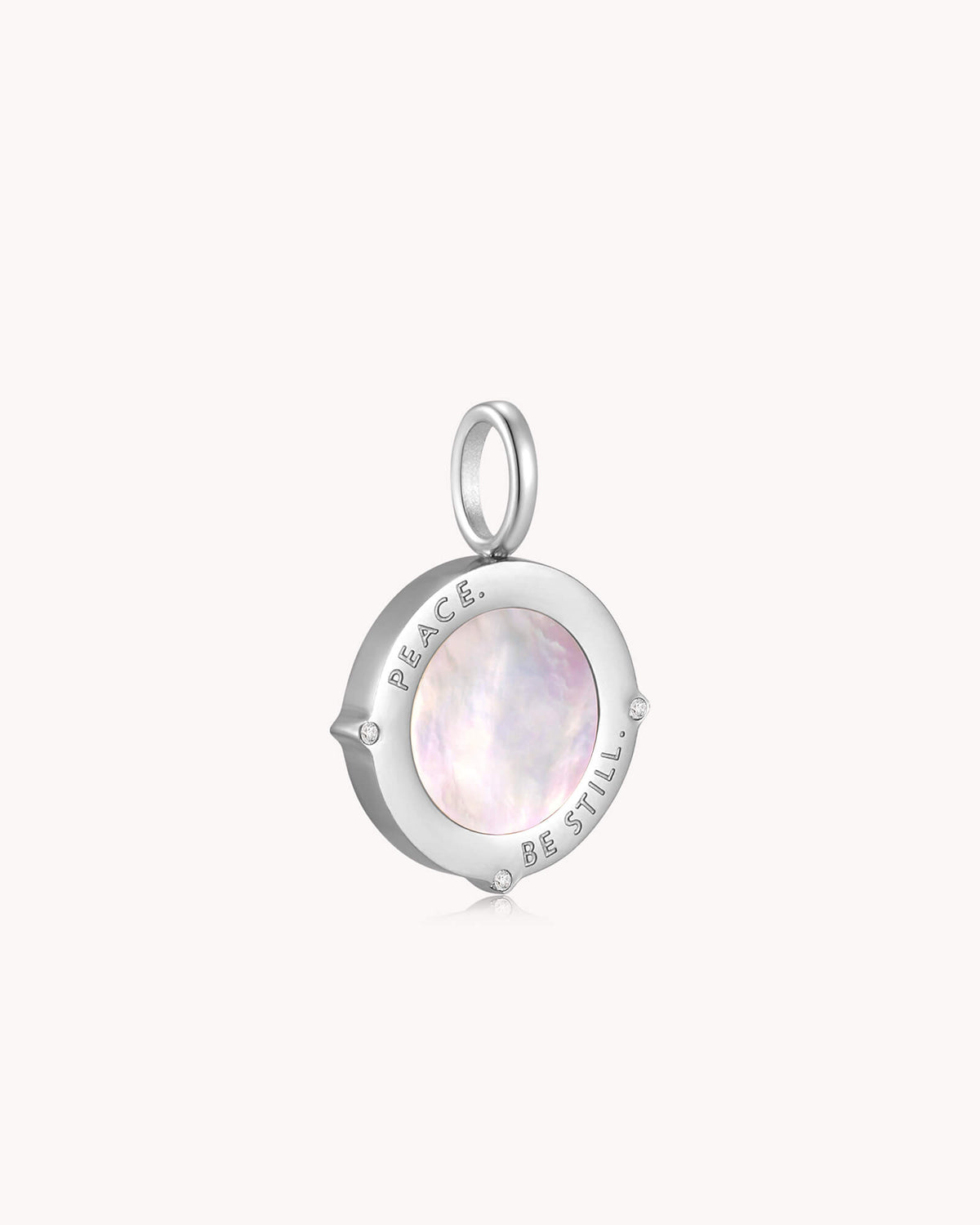 Angled view of Peace Be Still Mark 4:39 White Gold Pendant